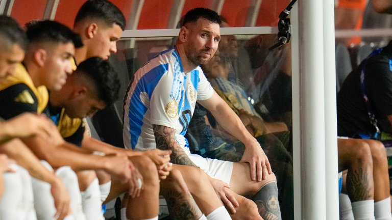 Argentina's Lionel Messi sits on the bench after leaving the field injured during the Copa America final soccer match against Colombia in Miami Gardens, Fla., Sunday, July 14, 2024. (Julio Cortez/AP)