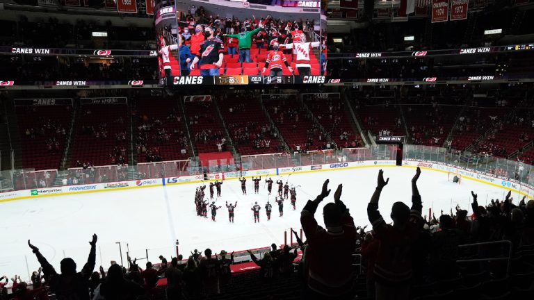 Carolina Hurricanes fans celebrate with the team following an NHL hockey game. (Gerry Broome/AP)