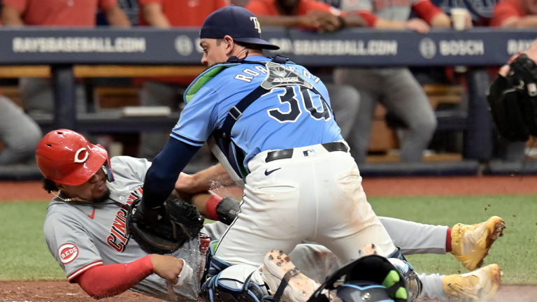 Tampa Bay Rays catcher Ben Rortvedt (30) tags out Cincinnati Reds' Santiago Espinal trying to score from third base on a run-down during the second inning of a baseball game, Sunday, July 28, 2024, in St. Petersburg, Fla. (Steve Nesius/AP)
