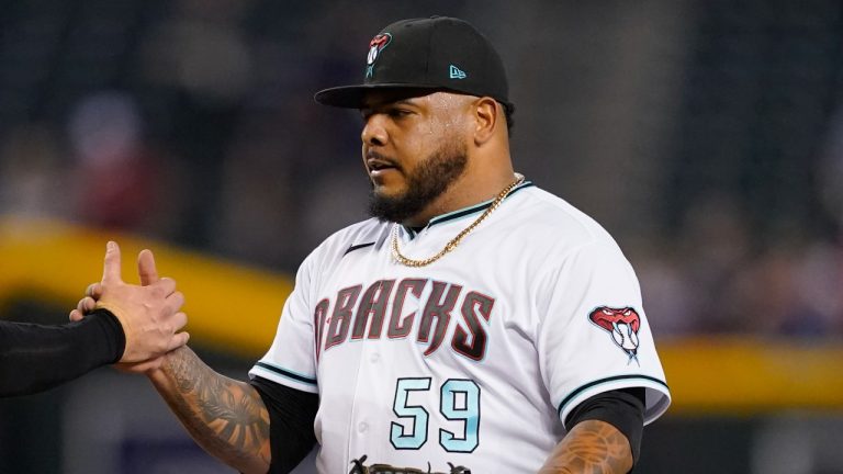 Arizona Diamondbacks' relief pitcher Reyes Moronta celebrates with catcher Carson Kelly after a game against the San Diego Padres, Sept. 15, 2022. (AP Photo/Matt York)