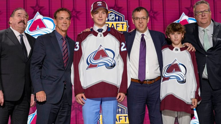 Calum Ritchie poses with Colorado Avalanche officials after being picked by the team during the first round of the NHL hockey draft Wednesday, June 28, 2023, in Nashville, Tenn. (George Walker IV/AP Photo)