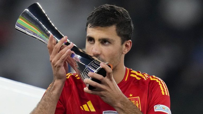 Spain's Rodri kisses his Best Player of the tournament trophy after the final match between Spain and England at the Euro 2024 soccer tournament in Berlin, Germany, Sunday, July 14, 2024. (Manu Fernandez/AP Photo)