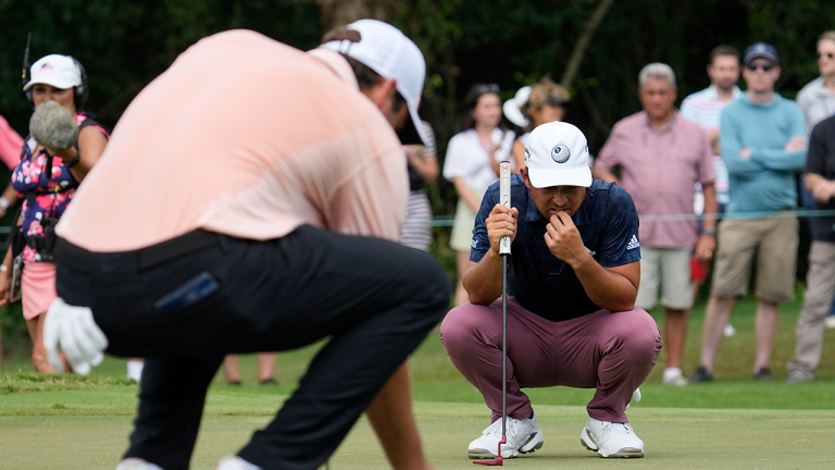 Scottie Scheffler, left and Xander Schauffele check the line for their putts on the seventh green during the second round of the Tour Championship golf tournament at East Lake Golf Club, Friday, Aug. 26, 2022, in Atlanta. (Steve Helber/AP)