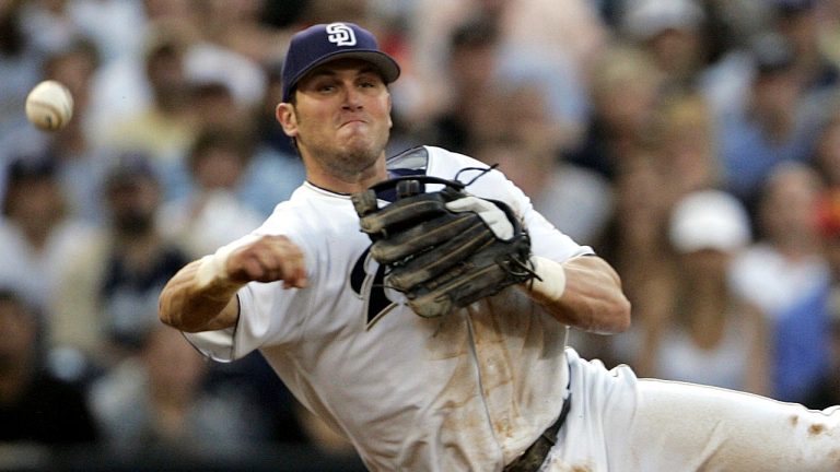 San Diego Padres third baseman Sean Burroughs fires a throw to first from his knees during the third inning of a game against the Los Angeles Dodgers, June 22, 2005. (AP Photo/Lenny Ignelzi)