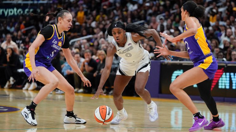 Las Vegas Aces guard Jackie Young (0) drives against Los Angeles Sparks forward Dearica Hamby, left, and guard Rae Burrell during the second half of a WNBA basketball game Friday, July 5, 2024, in Los Angeles. (Ryan Sun/AP)