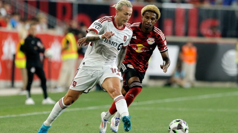 Toronto FC's Federico Bernardeschi, left, drives the ball while followed by New York Red Bulls' Kyle Duncan, right, during a Leagues Cup soccer match at Red Bull Arena, Saturday, July 27, 2024, in Harrison, N.J. (Andres Kudacki/AP)