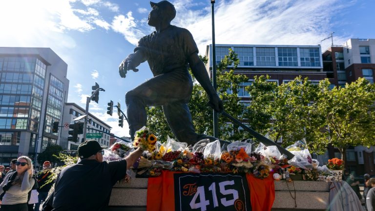 Kerry Whitney of Napa places a bouquet of flowers at the feet of the Willie Mays statue before the San Francisco Giants played the Chicago Cubs at Oracle Park in San Francisco, Monday, June 24, 2024. The Giants held a pre-game tribute for former San Francisco Giant and baseball Hall of Famer Willie Mays to honor him after he passed away a week earlier. (Carlos Avila Gonzalez/San Francisco Chronicle via AP)