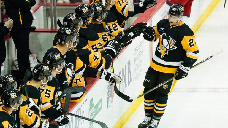 Pittsburgh Penguins' Corey Andonovski (27) is greeted by teammates on the bench after scoring the tying goal against the Columbus Blue Jackets during the third period of an NHL pre-season hockey game, Sunday, Sept. 25, 2022, in Pittsburgh. (Keith Srakocic/AP)
