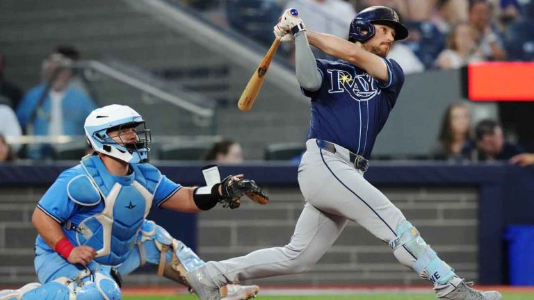 Tampa Bay Rays' Brandon Lowe (right) hits a two-run home run as Toronto Blue Jays catcher Alejandro Kirk looks on during fifth inning American League MLB baseball action. (Chris Young/CP)