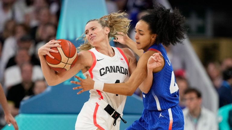 Sami Hill, of Canada, is tied up by Leila Lacan, of France, in a women's basketball game at the 2024 Summer Olympics, Monday, July 29, 2024, in Villeneuve-d'Ascq, France. (Mark J. Terrill/AP Photo)