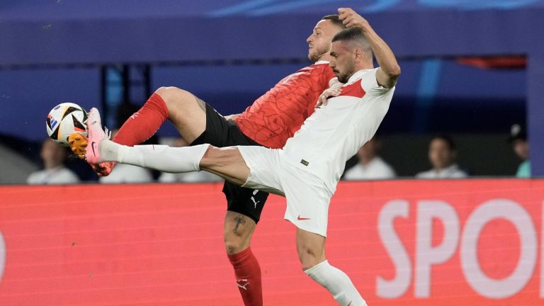 Turkey's Merih Demiral, foreground, and Austria's Marko Arnautovic fight for the ball during a round of sixteen match at the Euro 2024 soccer tournament in Leipzig, Germany, Tuesday, July 2, 2024. (Thanassis Stavrakis/AP)