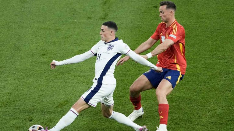 England's Phil Foden, left, and Spain's Fabian Ruiz vie for the ball during the final match at the Euro 2024 soccer tournament. (Thanassis Stavrakis/AP)