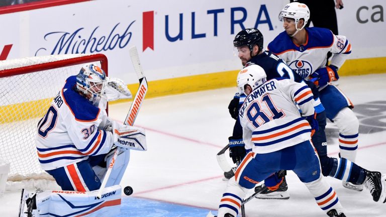 Edmonton Oilers' goaltender Calvin Pickard (30) makes a save on Winnipeg Jets' Jeffrey Viel (28) as Noel Hoefenmayer (81) defends during first period NHL preseason action in Winnipeg on Monday September 25, 2023. (Fred Greenslade/CP)