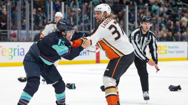 Seattle Kraken left winger Brandon Tanev (13) and Anaheim Ducks defenceman William Lagesson (37) fight during the third period of an NHL hockey game Thursday, March 28, 2024, in Seattle. (Jason Redmond/AP)