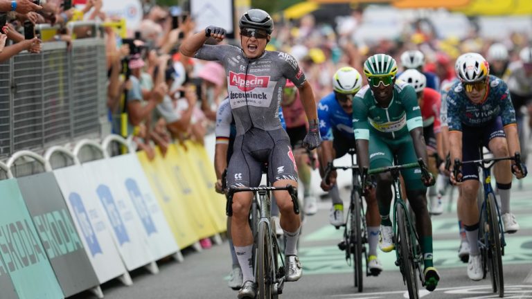 Belgium's Jasper Philipsen celebrates as he crosses the finish line to win the tenth stage of the Tour de France cycling race with a start in Orleans and finish in Saint-Amand-Montrond, France, Tuesday, July 9, 2024. (Jerome Delay/AP)