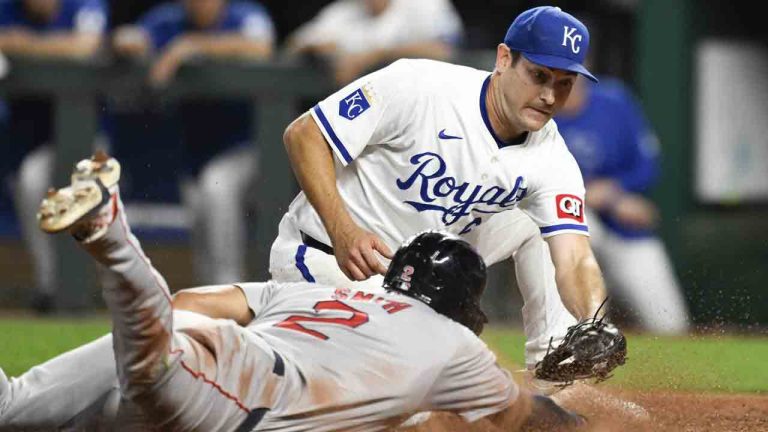 Boston Red Sox's Dominic Smith (2) beats the tag by Kansas City Royals starting pitcher Seth Lugo to score during the sixth inning of a baseball game, Tuesday, Aug. 6, 2024, in Kansas City, Mo. (Reed Hoffmann/AP)