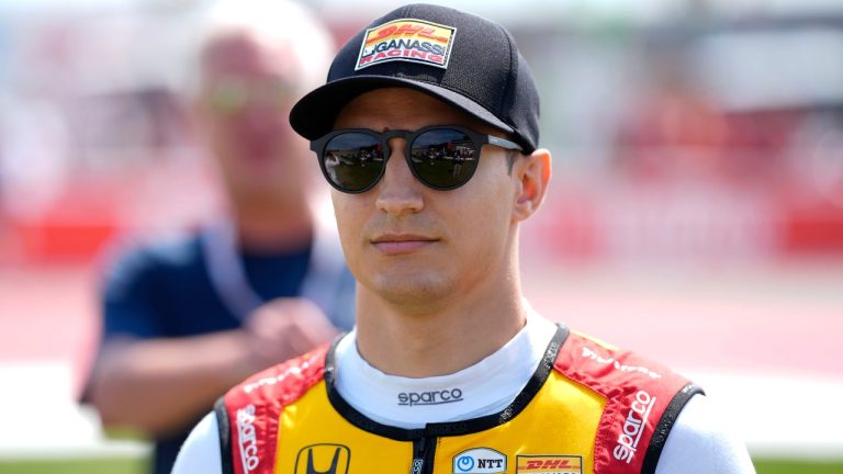 Alex Palou walks to driver introductions before an IndyCar auto race, Sunday, July 14, 2024, at Iowa Speedway in Newton, Iowa. (AP Photo/Charlie Neibergall)