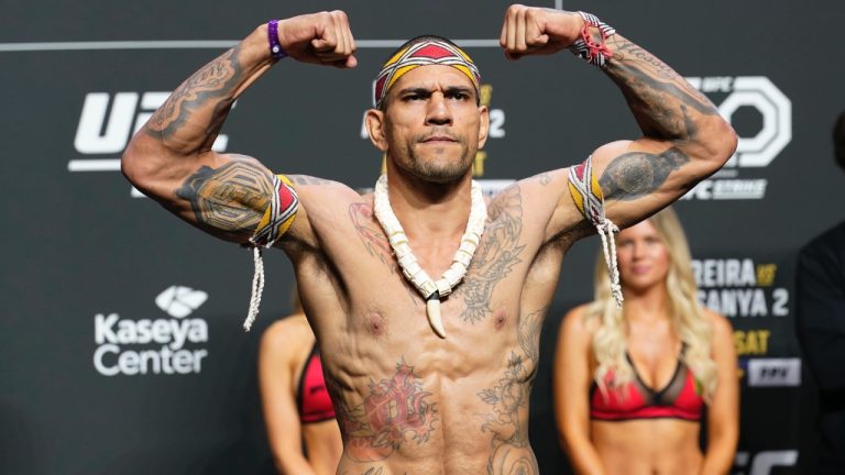 Alex Pereira raises his fists during a UFC ceremonial weigh-in. (Marta Lavandier/AP)