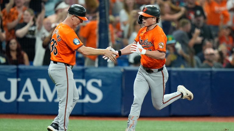 Baltimore Orioles' Jackson Holliday celebrates with third base coach Tony Mansolino (36) after his solo home run off Tampa Bay Rays relief pitcher Tyler Alexander during the second inning of a baseball game Saturday, Aug. 10, 2024, in St. Petersburg, Fla. (Christopher O'Meara/AP)