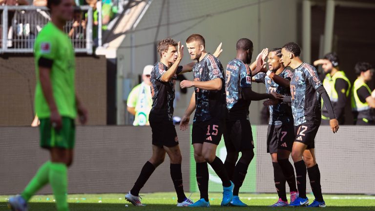 Bayern's Serge Gnabry, second right, celebrates with his teammates after scoring his side's third goal of the game during the German Bundesliga soccer match between VfL Wolfsburg and FC Bayern Munich at the Volkswagen Arena in Wolfsburg, Germany, Sunday, Aug. 27, 2024. (Swen Pfoertner/dpa via AP)