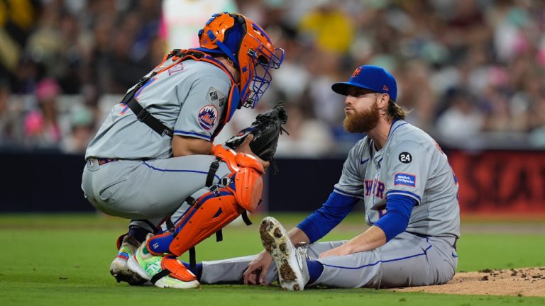 New York Mets starting pitcher Paul Blackburn, right, talks to catcher Francisco Alvarez after getting hit by a line out by San Diego Padres' David Peralta during the third inning of a baseball game Friday, Aug. 23, 2024, in San Diego. (Gregory Bull/AP)