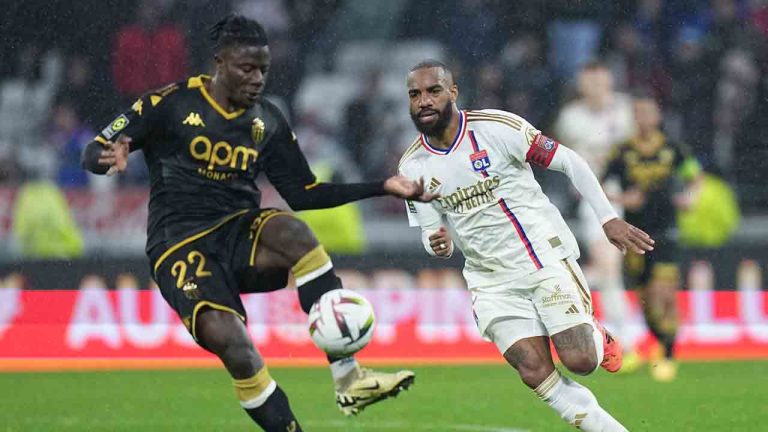 Monaco's Mohammed Salisu, left, and Lyon's Alexandre Lacazette vie for the ball during a French League One soccer match between Lyon and Monaco at the Groupama stadium in Decines, outside Lyon, France, Sunday, April 28, 2024. (Laurent Cipriani/AP)