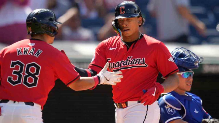 Cleveland Guardians' Bo Naylor, right, is congratulated by teammate Steven Kwan (38) as he crosses home plate in front of Kansas City Royals catcher Freddy Fermin, right, with a home run in the seventh inning of a baseball game Wednesday, Aug. 28, 2024, in Cleveland. (Sue Ogrocki/AP)