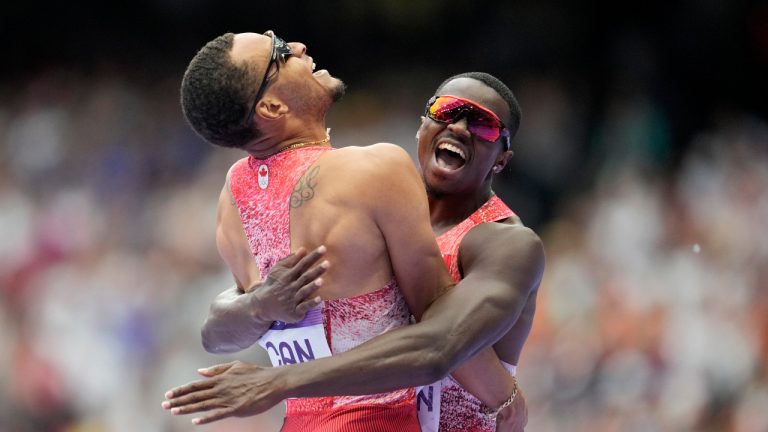 Aaron Brown, right, and Andre de Grasse, of Canada, celebrate after winning the gold medal in the men's 4 x 100 meters relay final at the 2024 Summer Olympics, Friday, Aug. 9, 2024, in Saint-Denis, France. (Ashley Landis/AP) 