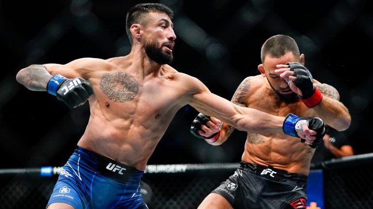 Chris Gutierrez, left, punches Frankie Edgar during the first round of a bantamweight bout at the UFC 281 mixed martial arts event Saturday, Nov. 12, 2022, in New York. Gutierrez stopped Edgar in the first round. (Frank Franklin II/AP)