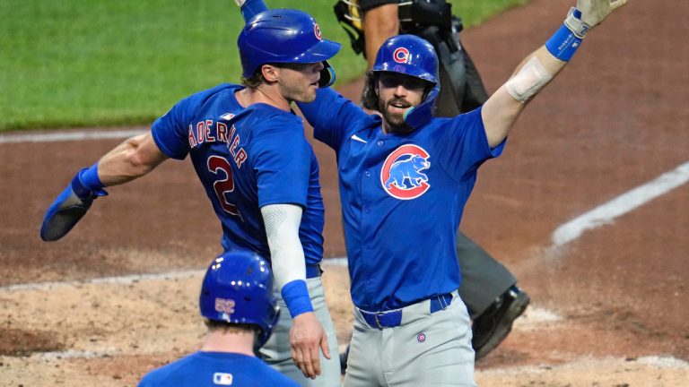 Chicago Cubs' Dansby Swanson, right, celebrates with Nico Hoerner, left, as he returns to the dugout after hitting a two-run home run off Pittsburgh Pirates starting pitch Jared Jones during the fourth inning of a baseball game in Pittsburgh, Tuesday, Aug. 27, 2024. (Gene J. Puskar/AP)