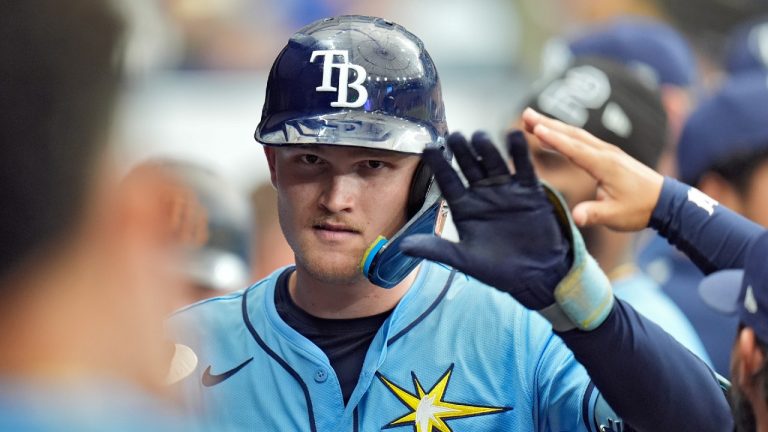 Tampa Bay Rays' Curtis Mead celebrates with teammates after his run scoring sacrifice fly off Baltimore Orioles relief pitcher Craig Kimbrel scored Brandon Lowe during the eighth inning of a baseball game Sunday, Aug. 11, 2024, in St. Petersburg, Fla. (Christopher O'Meara/AP)