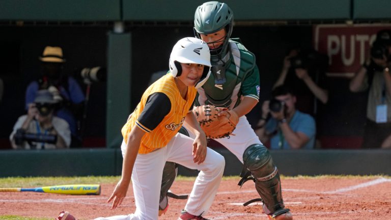 Taiwan's Yu Chia-Jui, right, tags out Lake Mary, Fla.'s Jacob Bibaud, left, who was attempting to score from third on a fielder's choice hit into by Teraj Alexander during the second inning of the Little League World Series Championship game in South Williamsport, Pa., Sunday, Aug. 25, 2024. (Gene J. Puskar/AP)
