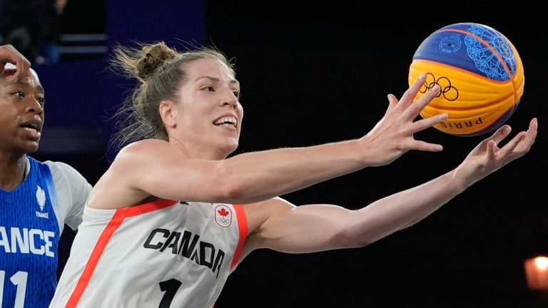 Canada's Michelle Plouffe fights for a rebound with Myriam Djekoundade, of France, in the women's 3x3 pool round match during the 2024 Summer Olympics, Aug. 1, 2024. (AP Photo/Frank Franklin II)