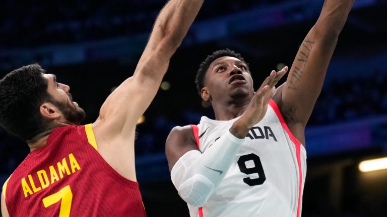 RJ Barrett, of Canada, shoots over Santi Aldama, of Spain, in a men's game at the 2024 Summer Olympics, Aug. 2, 2024. (AP Photo/Mark J. Terrill)