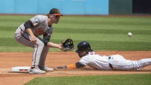 Cleveland Guardians' Jose Ramirez, right, safely steals second base as Baltimore Orioles' Gunnar Henderson, left, waits for the throw during the first inning of a baseball game in Cleveland, Sunday, Aug. 4, 2024. (Phil Long/AP)