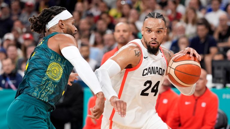 Canada's Dillon Brooks, right, drives pas Australia's Patty Mills in a men's basketball game at the 2024 Summer Olympics, Tuesday, July 30, 2024, in Villeneuve-d'Ascq, France. (Michael Conroy/AP Photo)