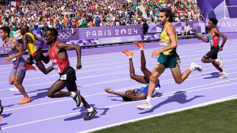 Abdihamid Nur, of the United States, falls during a heat in the men's 5000-meter round at the 2024 Summer Olympics, Wednesday, Aug. 7, 2024, in Saint-Denis, France. (Bernat Armangue/AP Photo)