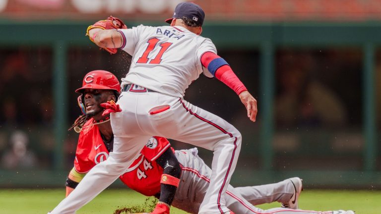 Cincinnati Reds' Elly De La Cruz (44) slides into second base as Atlanta Braves shortstop Orlando Arcia (11) attempts to tag him in the first inning of the first baseball game, Wednesday, July 24, 2024, in Atlanta. (Jason Allen/AP)