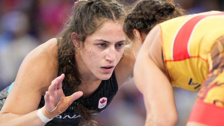 Romania's Kriszta Incze, in red, and Canada's Ana Paula Godinez Gonzalez compete in their women's freestyle 62kg repechage wrestling match, at Champ-de-Mars Arena, during the 2024 Summer Olympics, Saturday, Aug. 10, 2024, in Paris, France. (Eugene Hoshiko/AP Photo)