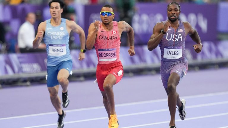 Canada's Andre De Grasse, centre, of Markham, Ont., competes in the men’s 200m qualifying heat at the 2024 Summer Olympics, Monday, Aug. 5, 2024, in Saint-Denis, France. The 29-year-old crossed the finish line in 20.30 seconds to finish second in Heat 6. (Christinne Muschi/THE CANADIAN PRESS)