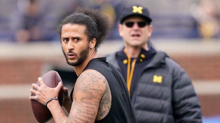 Michigan head football coach Jim Harbaugh watches as former NFL quarterback Colin Kaepernick throws during halftime of an NCAA college football intra-squad spring game, Saturday, April 2, 2022, in Ann Arbor, Mich. (Carlos Osorio/AP)