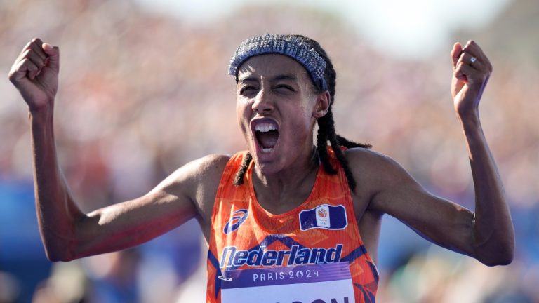Sifan Hassan, of the Netherlands, celebrates after crossing the finish line to win the gold medal at the end of the women's marathon competition at the 2024 Summer Olympics, Sunday, Aug. 11, 2024, in Paris, France. (Vadim Ghirda/AP Photo)