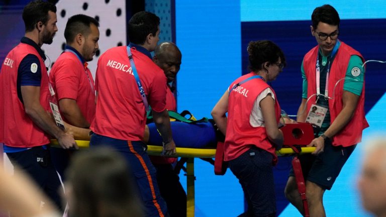 Slovakia’s Tamara Potocka is taken on stretcher from the pool deck after collapsing following a heat of the women's 200-meter individual medley at the 2024 Summer Olympics, Friday, Aug. 2, 2024, in Nanterre, France. (Tsvangirayi Mukwazh/AP Photoi)