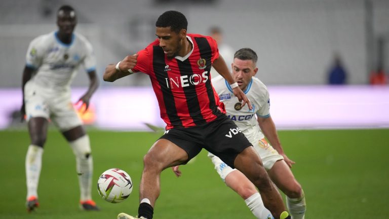 Nice's Jean-Clair Todibo, centre, challenges for the ball with Marseille's Jordan Veretout during the French League One soccer match between Olympique de Marseille and Nice at the Velodrome stadium in Marseille, south of France, Wednesday, April 24, 2024. (Daniel Cole/AP)