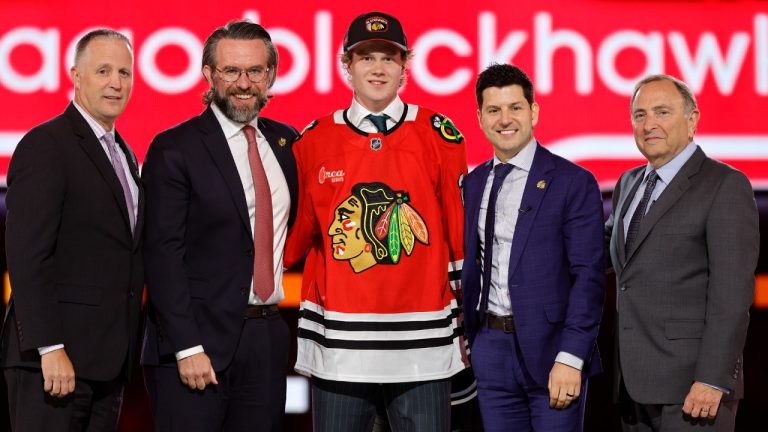 Marek Vanacker, centre, poses after being selected by the Chicago Blackhawks during the first round of the NHL hockey draft Friday, June 28, 2024, in Las Vegas. (Steve Marcus/AP)