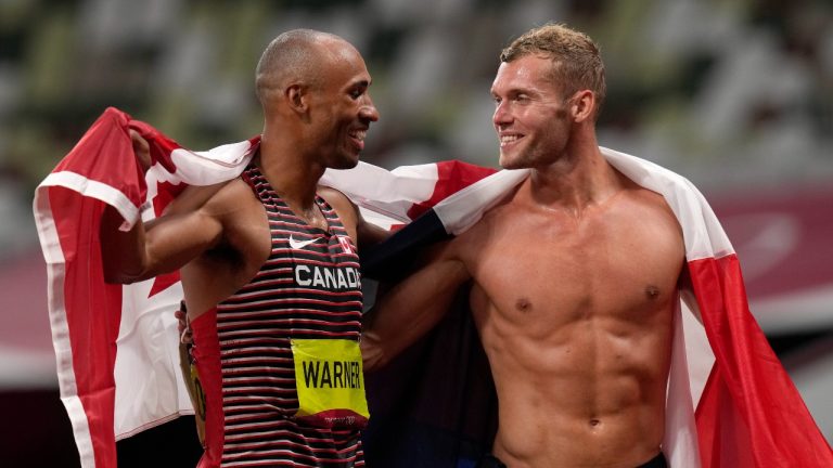 Damian Warner, of Canada smiles at Kevin Mayer, of France, silver, after winning the gold medal in the decathlon at the 2020 Summer Olympics, Thursday, Aug. 5, 2021, in Tokyo, Japan. (Francisco Seco/AP Photo)
