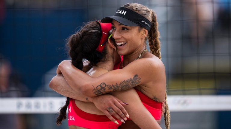 Canada's Melissa Humana-Paredes, left, and Brandie Wilkerson react during the women's pool D beach volleyball match between Canada and Latvia at Eiffel Tower Stadium at the 2024 Summer Olympics, Saturday, Aug. 3, 2024, in Paris, France. (Louise Delmotte/AP Photo)