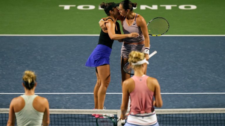 Caroline Dolehide, of the United States, right, embraces teammate Desirae Krawczyk, of the United States, after their win against Gabriela Dabrowski, of Ottawa, and Erin Routliffe, of New Zealand, during women's doubles final action at the National Bank Open, in Toronto, Monday, Aug. 12, 2024. (Chris Young/CP)