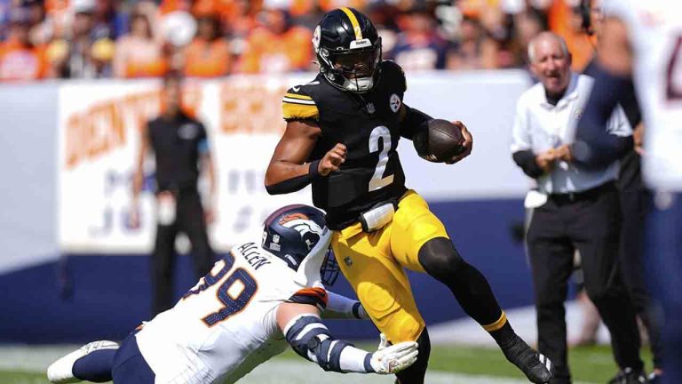 Pittsburgh Steelers quarterback Justin Fields (2) runs against Denver Broncos defensive end Zach Allen (99) during the first half of an NFL football game, Sunday, Sept. 15, 2024, in Denver. (David Zalubowski/AP)