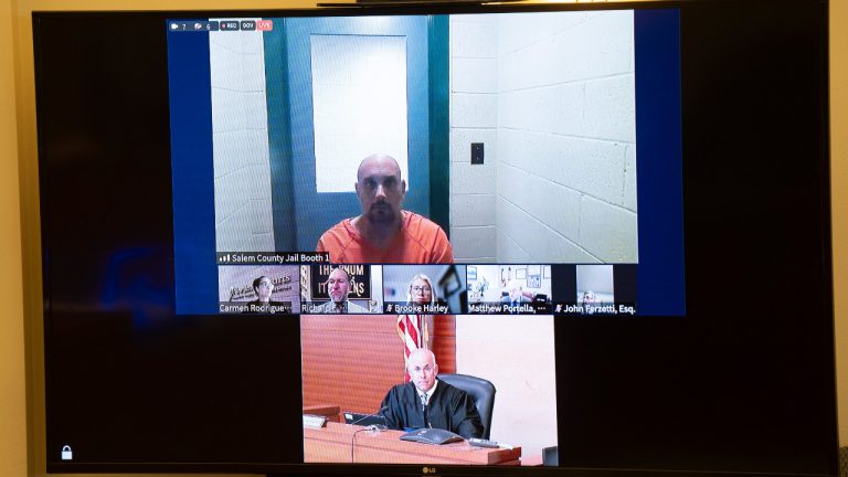 Sean M. Higgins, top, the suspected drunken driver charged with killing NHL hockey player Johnny Gaudreau and his brother Matthew as they bicycled on a rural road, appears before Judge Michael Silvanio, for his hearing via video from jail, Thursday Sept. 5, 2024, in Woodbury, N.J. (Matt Rourke/AP) 
